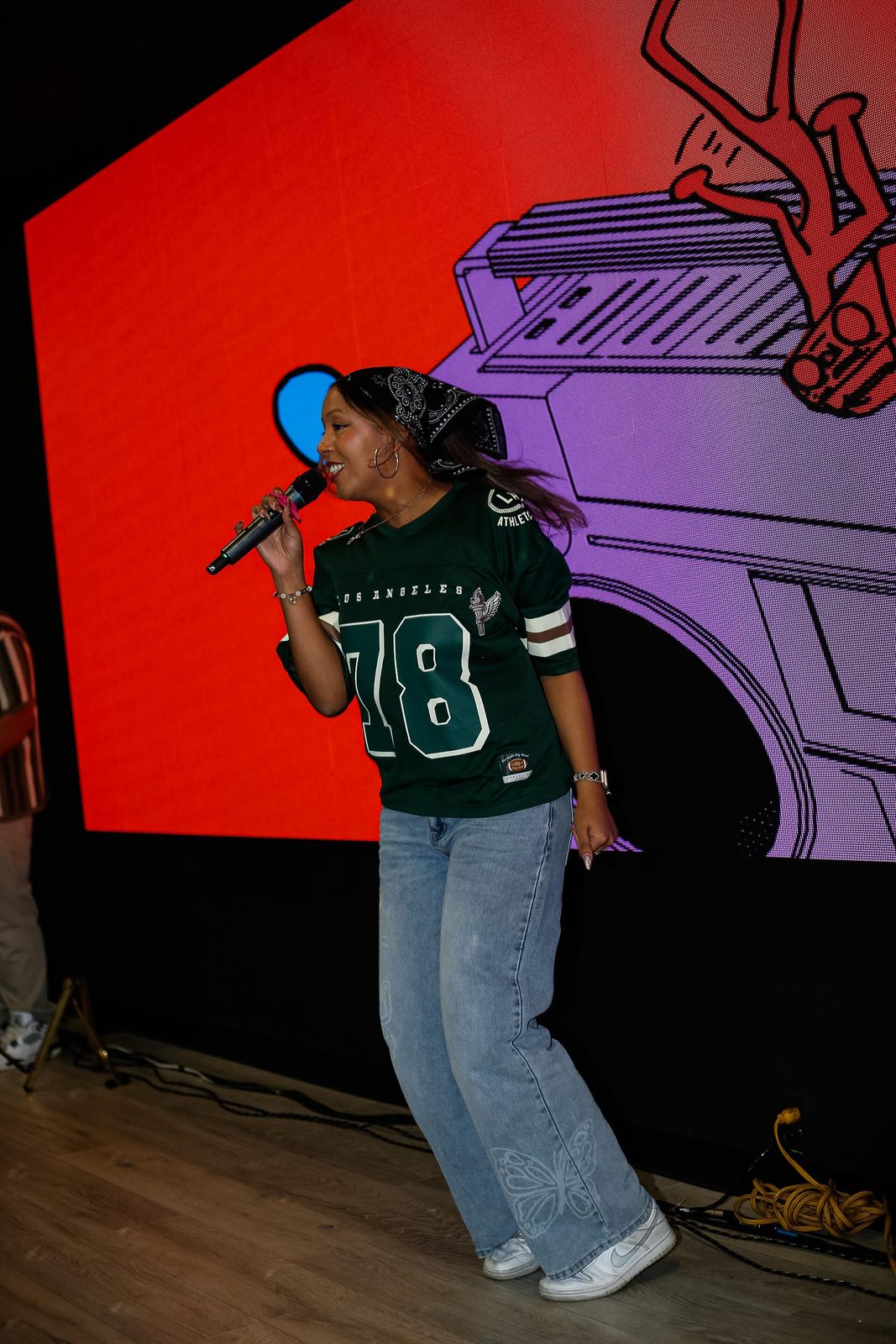 A QARA vocalist leading worship in front of the screen